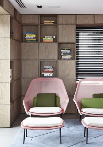 Pink chairs with footrest in retro living room