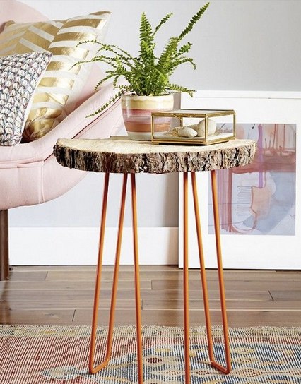 Wood trunk coffee table with orange legs and pink sofa