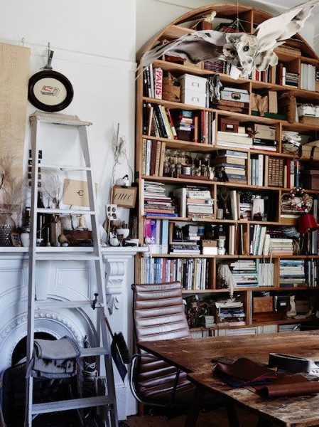 boho bookshelf in cluttered room