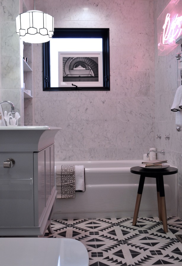 black and white bathroom with pink neon light