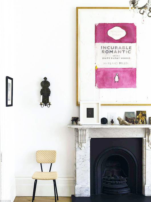 penguin books print artwork above fireplace