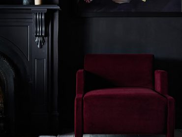 Home interior styles - ruby red chair and black wall
