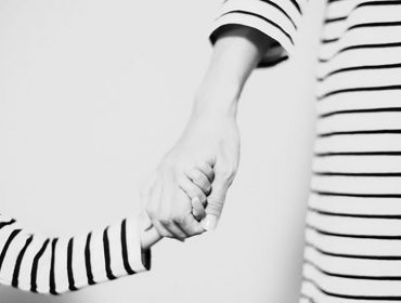 Mother's Day - Mother and child holding hands