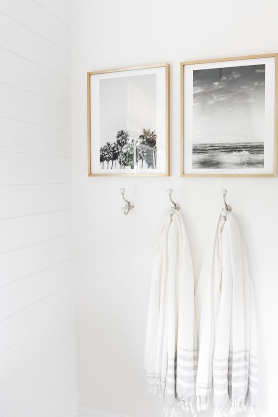 Small bathroom ideas - artwork and hooks with white towels