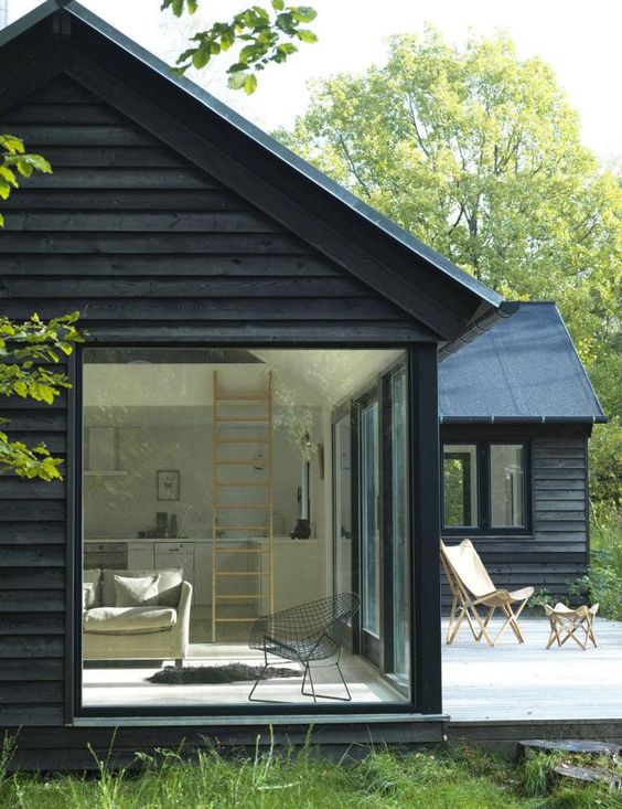 Home interior styles - black cabin in woods