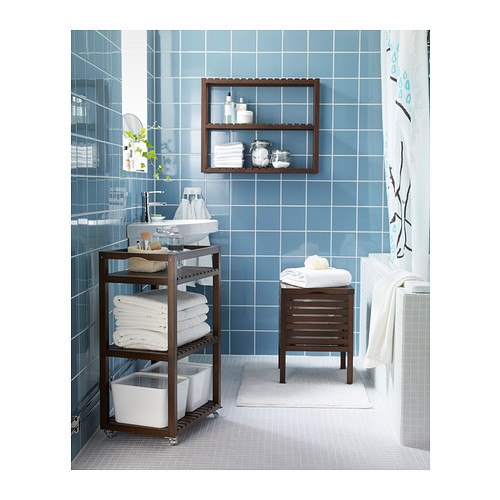 Small bathroom ideas - brown bathroom caddy with blue wall