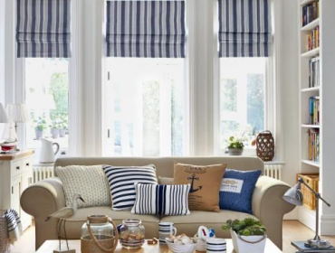 nautical living room couch and striped blinds