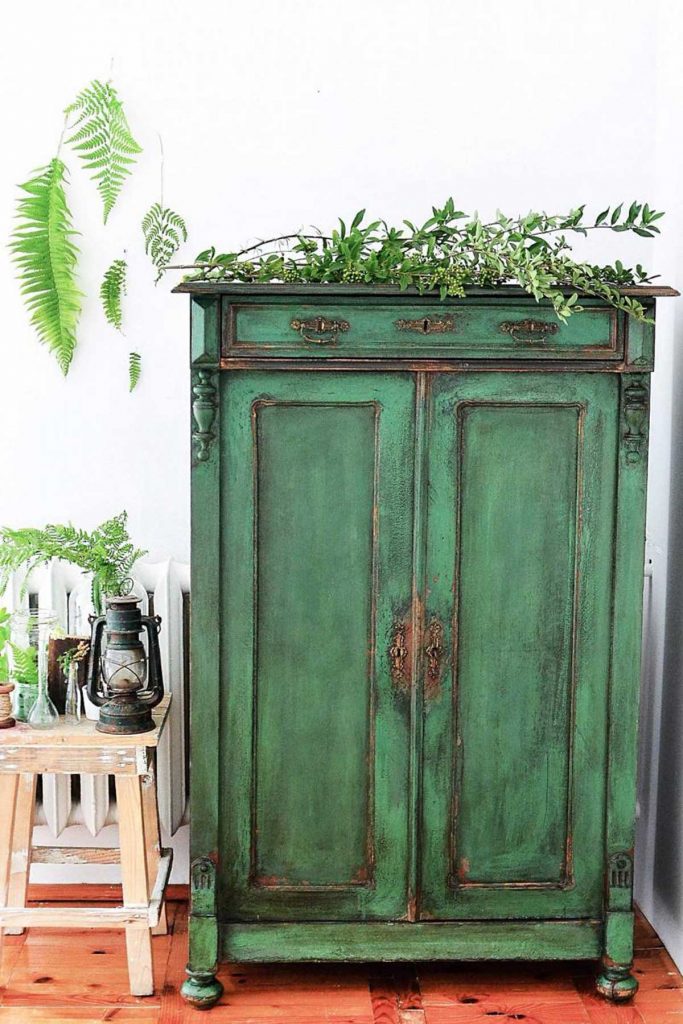 Vintage interior design green distressed cupboard