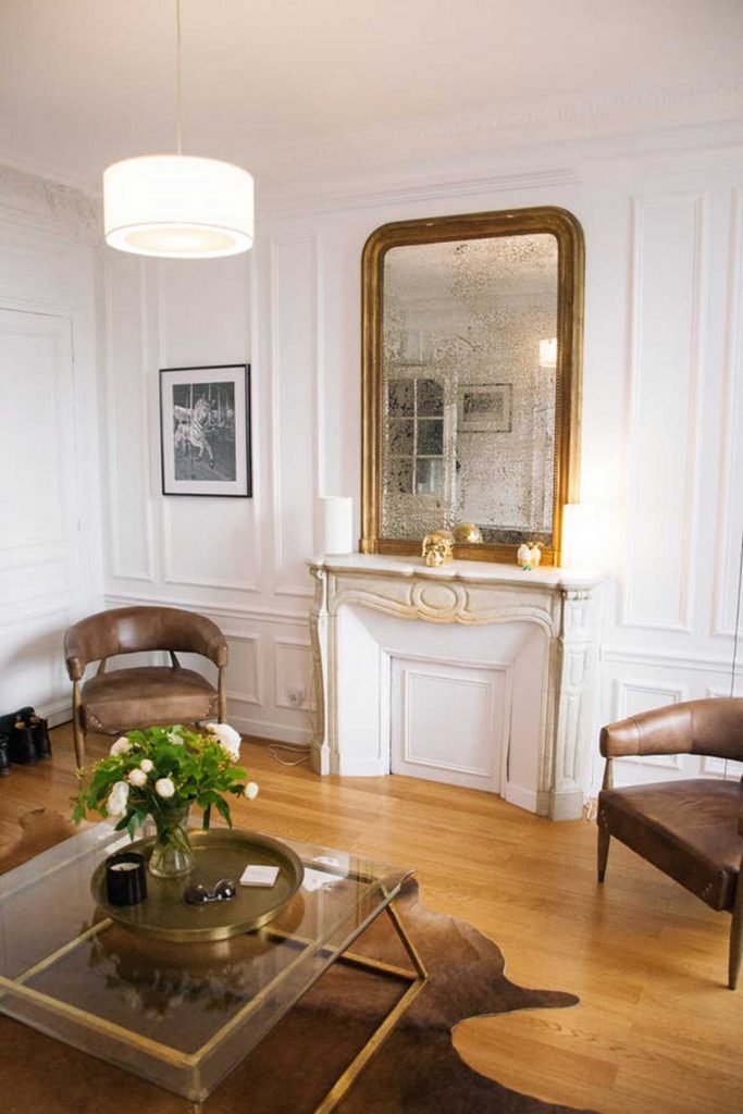 French accent style gold mirror above fireplace